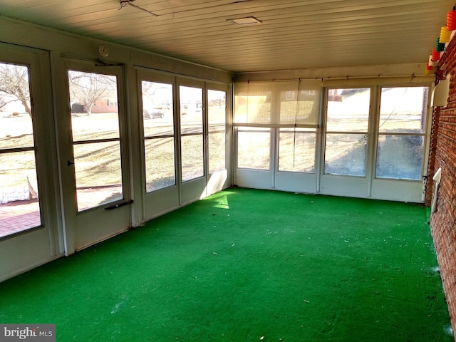 unfurnished sunroom with wooden ceiling