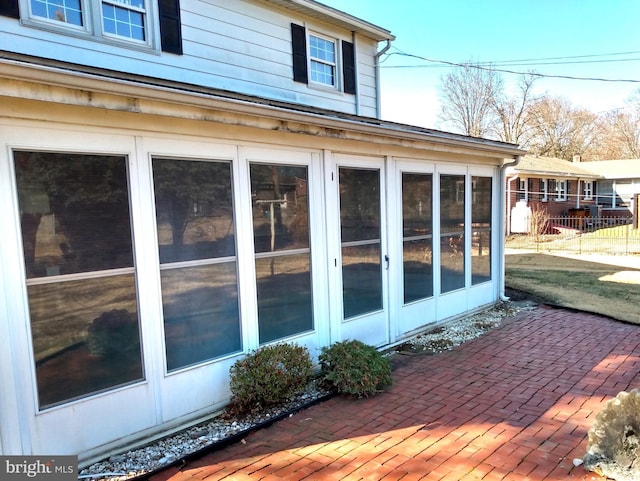 view of home's exterior with a patio area and fence