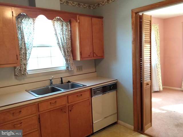 kitchen featuring a sink, light countertops, dishwasher, and light colored carpet