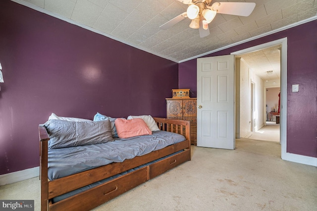 carpeted bedroom featuring a ceiling fan and baseboards