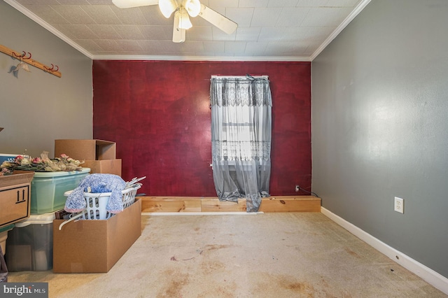 interior space with ceiling fan, baseboards, and crown molding