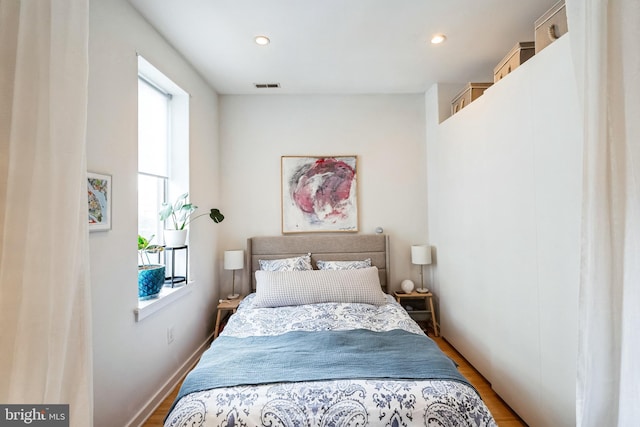 bedroom with light wood-style flooring, visible vents, and recessed lighting