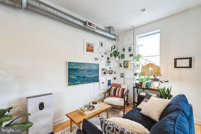 living area with wood finished floors and baseboards