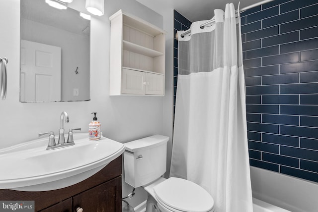 bathroom featuring shower / bath combo with shower curtain, toilet, and vanity