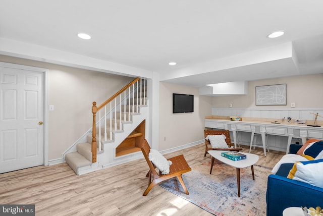 living room featuring recessed lighting, light wood-type flooring, baseboards, and stairway