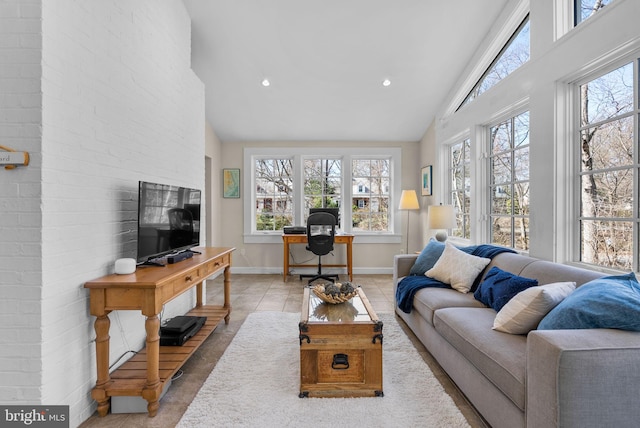 tiled living area with recessed lighting, baseboards, and high vaulted ceiling