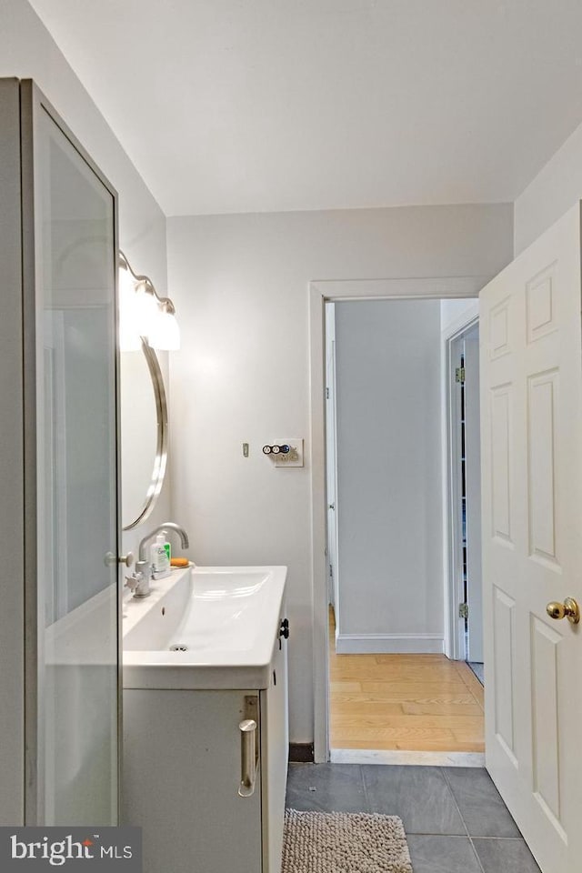 bathroom featuring tile patterned flooring and vanity