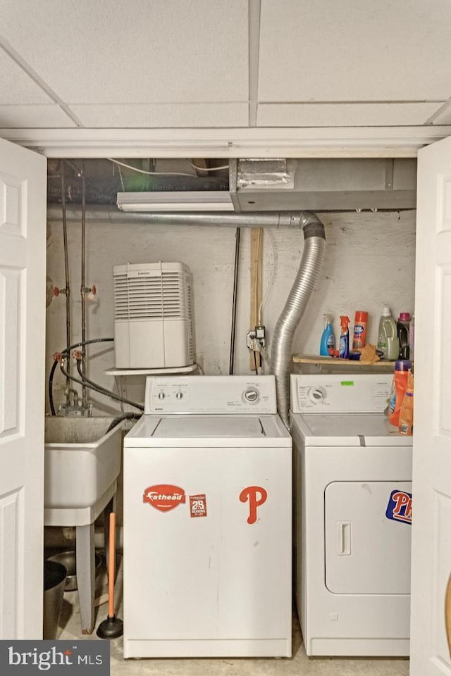 laundry room featuring a sink and washing machine and clothes dryer