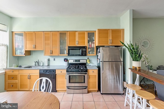 kitchen featuring black appliances, light countertops, a sink, and light tile patterned flooring