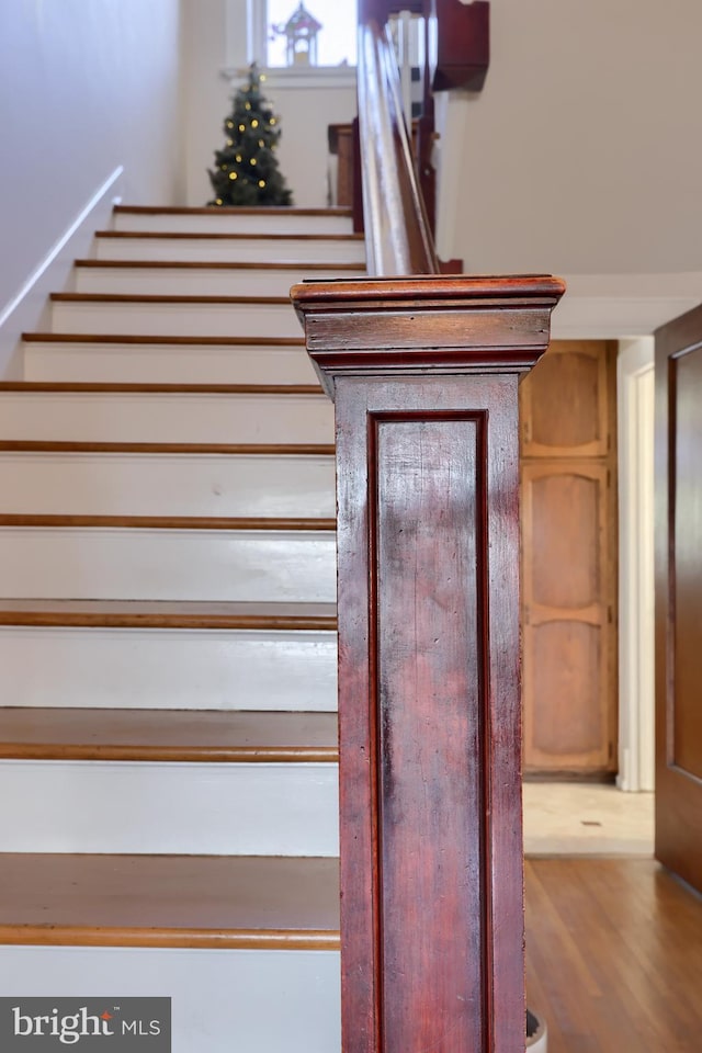 staircase with wood finished floors