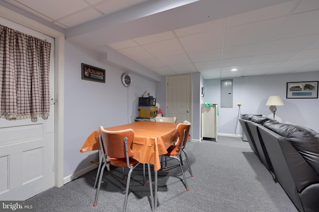 dining area with electric panel, carpet, baseboards, and a drop ceiling