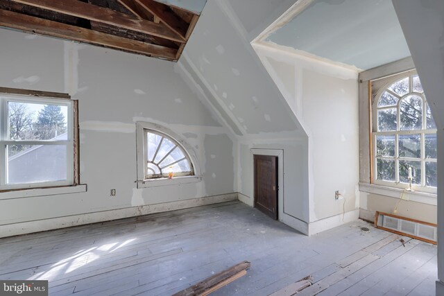 bonus room with a wealth of natural light, visible vents, and hardwood / wood-style flooring