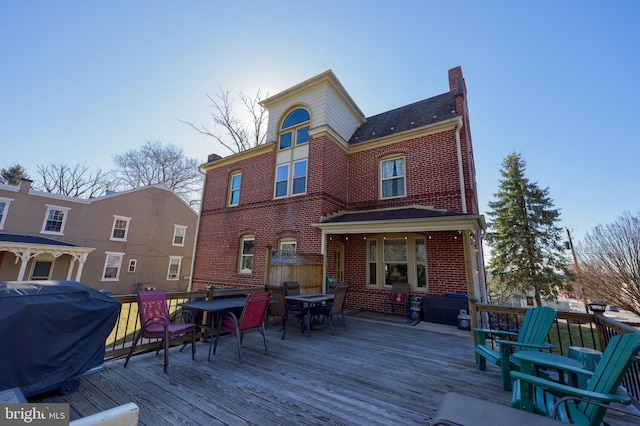 deck featuring outdoor dining space and area for grilling