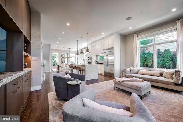 living room with recessed lighting and dark wood finished floors