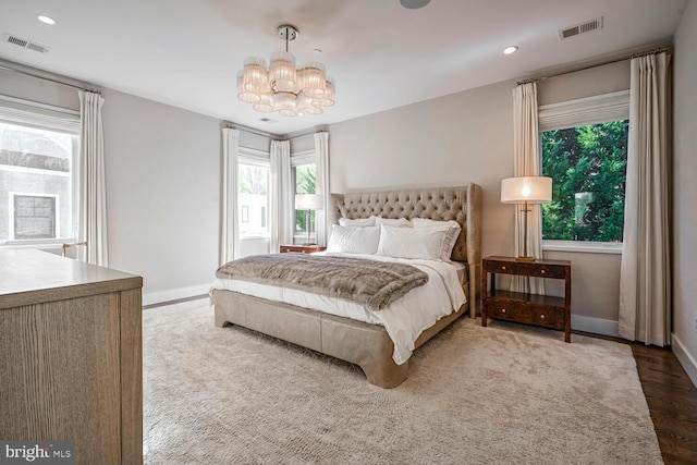 bedroom featuring visible vents, baseboards, and a chandelier