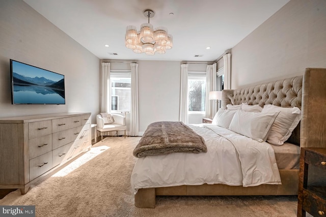 bedroom featuring light carpet, a notable chandelier, recessed lighting, and visible vents