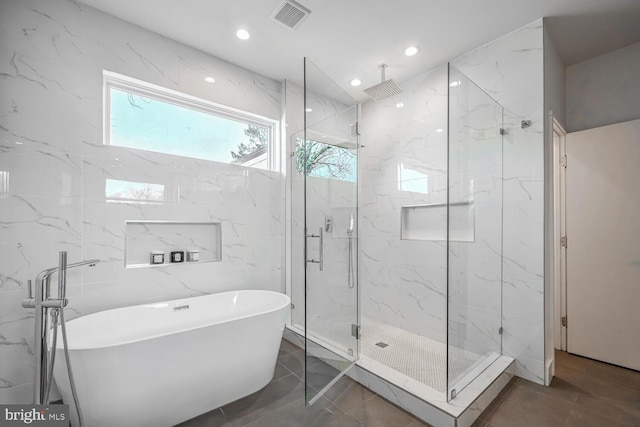 full bathroom with a marble finish shower, visible vents, a soaking tub, and recessed lighting