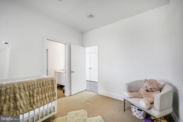 sitting room featuring baseboards and carpet