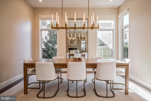 dining area with recessed lighting, baseboards, and an inviting chandelier