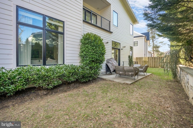 back of house with a patio, a lawn, and fence