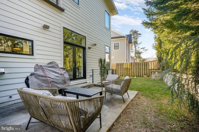 view of patio / terrace with a grill, outdoor lounge area, and fence