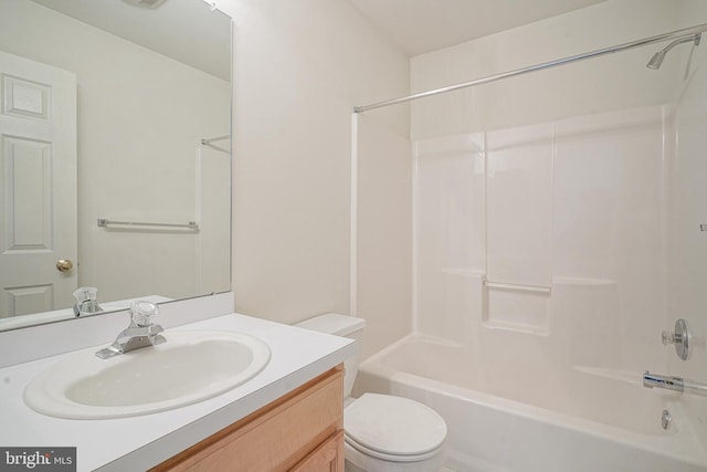 bathroom featuring vanity, bathing tub / shower combination, and toilet