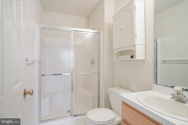 full bath with a shower stall, toilet, and vanity