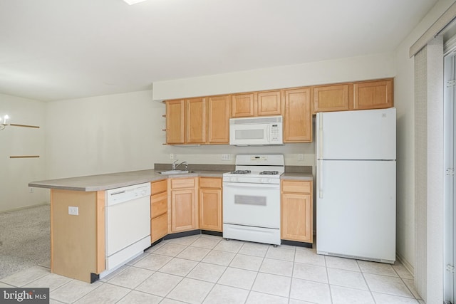 kitchen featuring light brown cabinets, light countertops, light tile patterned floors, white appliances, and a sink