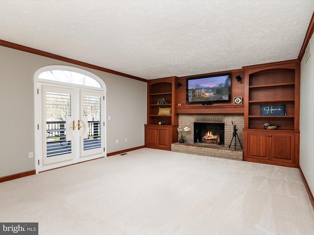 unfurnished living room with ornamental molding, carpet flooring, a fireplace, and a textured ceiling