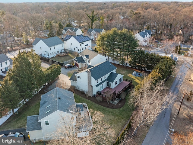 bird's eye view featuring a wooded view and a residential view