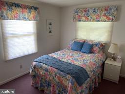 carpeted bedroom with baseboards