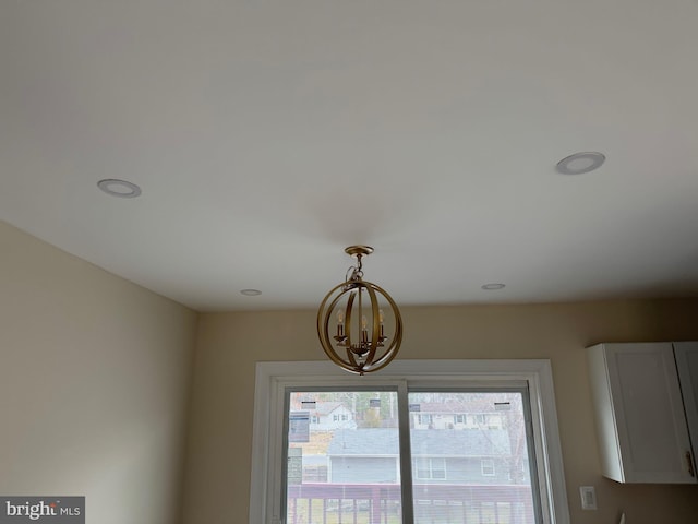 details featuring recessed lighting and a chandelier