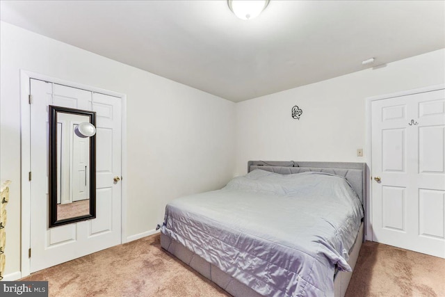 carpeted bedroom with baseboards