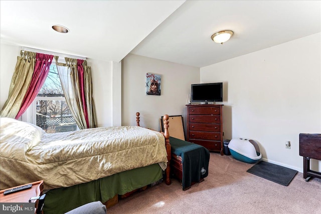 bedroom featuring carpet and baseboards