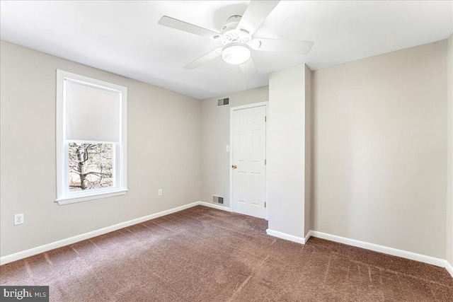 unfurnished bedroom with carpet floors, baseboards, visible vents, and a ceiling fan