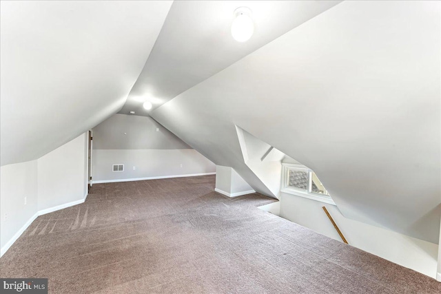 bonus room featuring carpet floors, baseboards, visible vents, and vaulted ceiling