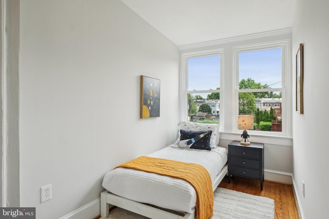 1707 D St SE, Washington, DC 20003 - bedroom featuring wood finished floors, baseboards, and lofted ceiling