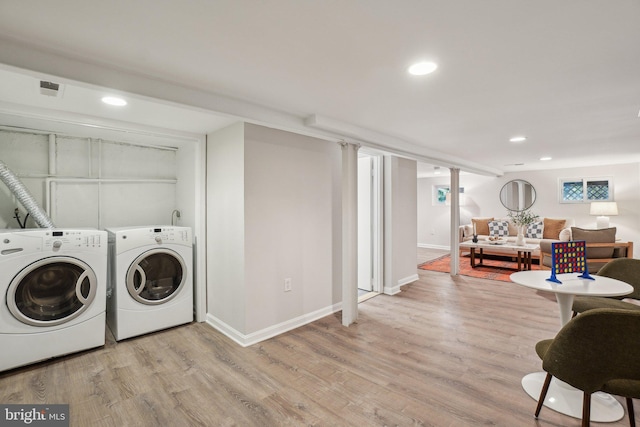 1707 D St SE, Washington, DC 20003 - washroom featuring washing machine and dryer, light wood-style floors, baseboards, and recessed lighting