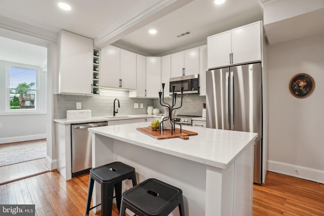 1707 D St SE, Washington, DC 20003 - kitchen featuring stainless steel appliances, baseboards, light wood-style flooring, white cabinets, and recessed lighting