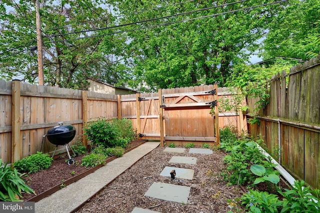 fenced backyard featuring a gate