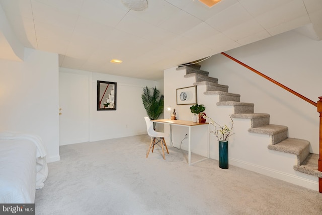 staircase featuring carpet flooring and baseboards