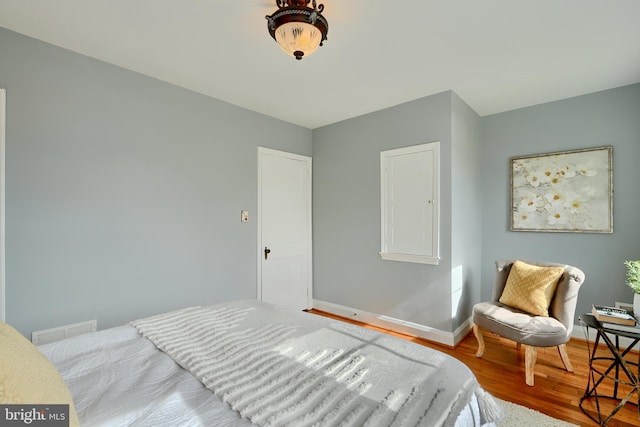 bedroom featuring wood finished floors and baseboards