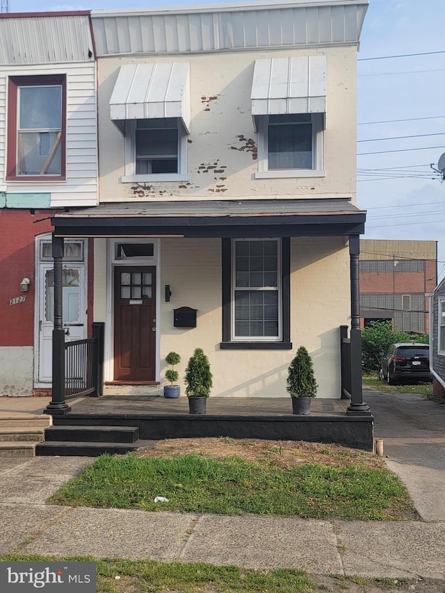 view of front of property featuring covered porch and stucco siding