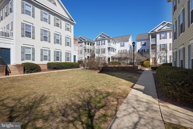 view of community with a yard and a residential view