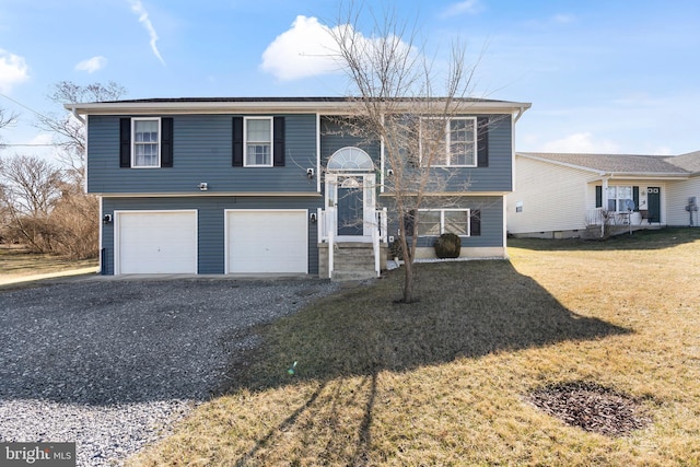 bi-level home featuring a garage, a front yard, and driveway