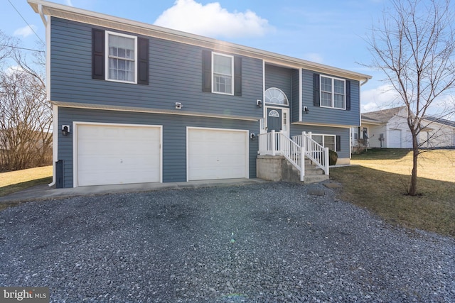 bi-level home with driveway and an attached garage