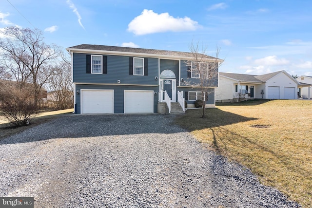 split foyer home with a front lawn, an attached garage, and driveway