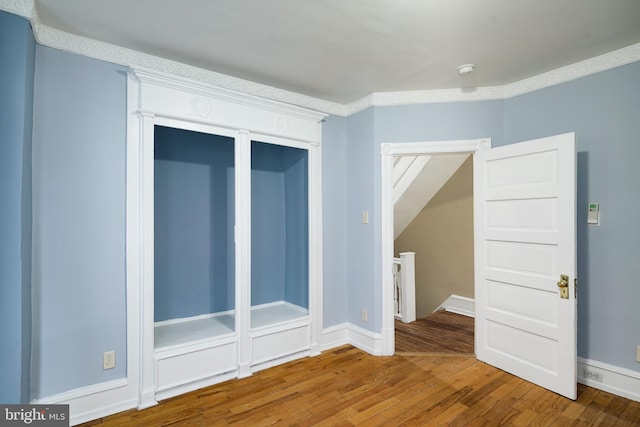 interior space featuring baseboards and wood finished floors