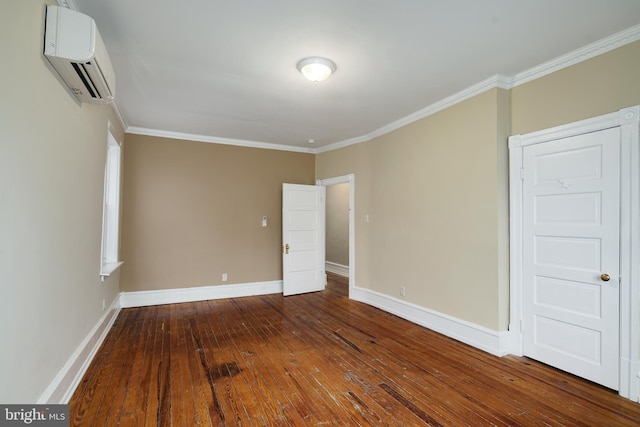 unfurnished room featuring baseboards, a wall mounted AC, ornamental molding, and wood-type flooring