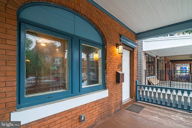 view of exterior entry with brick siding
